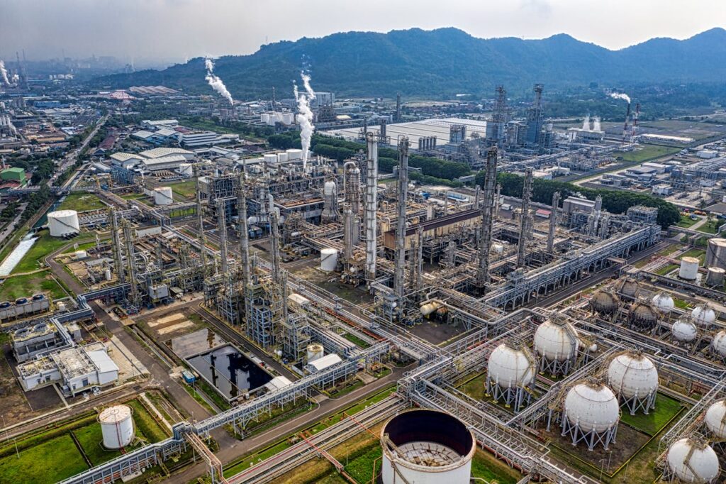 pexels-photo-6767962 Aerial view of a large industrial oil refinery in Banten, Indonesia with storage tanks and pipelines.